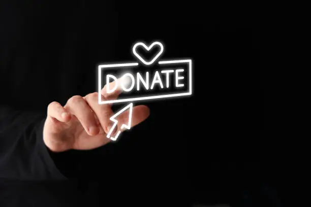 Photo of Hand touching donate icon.