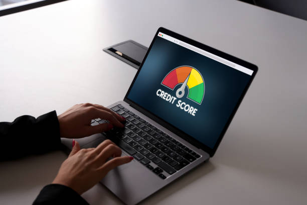 istock Woman using laptop with credit score on laptop screen 1776699758