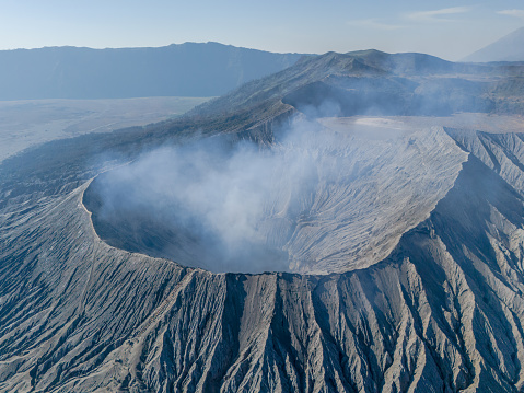 Active volcano crater, Bromo, East Java, Indonesia. Aerial panorama View of Smoke Gas Steam coming from crater at daytime