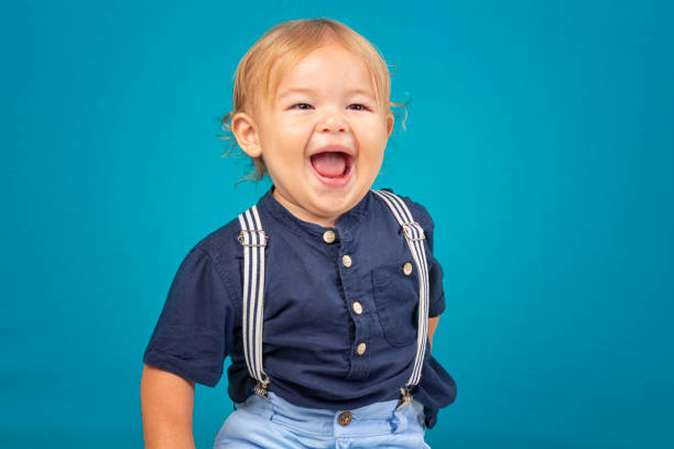 istock 2 year old boy in studio photo with blue background smiling and posing 1776721432