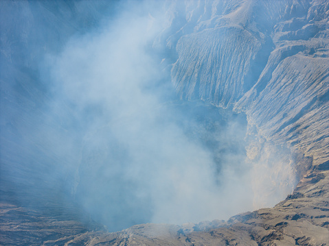 Active volcano crater, Bromo, East Java, Indonesia. Aerial panorama View of Smoke Gas Steam coming from crater at daytime