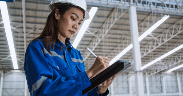 Young adult Asian woman, female technician engineer warehouse worker working in factory warehouse, using digital tablet. Logistic industry business, industrial job career, people at work concept Young adult Asian woman, female technician engineer warehouse worker working in factory warehouse, using digital tablet. Logistic industry business, industrial job career, people at work concept project manager remote stock pictures, royalty-free photos & images