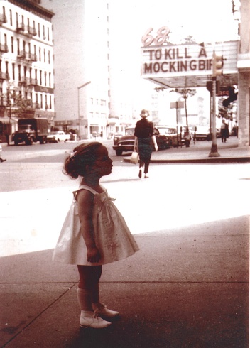 Young girl looking at NY window