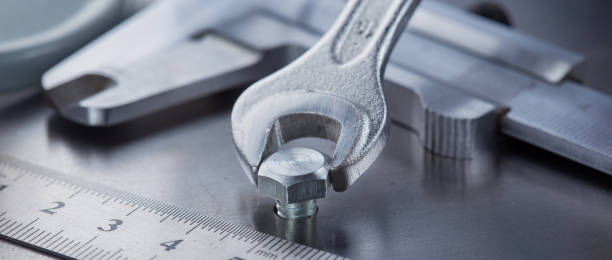 istock Wrench tightens bolt in steel billet. Spanner, bolt, screw and nuts. 1776753542