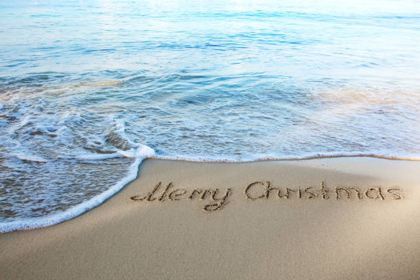 istock Merry Christmas text on the sea beach. 1776763074