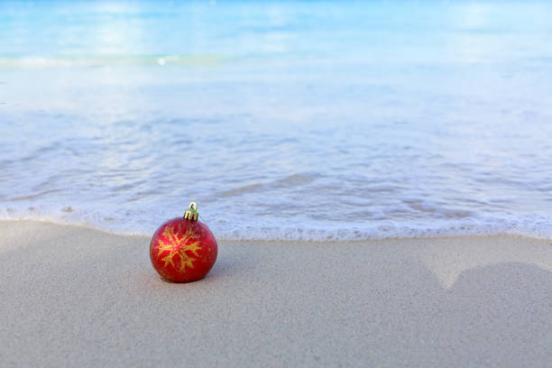 istock Christmas background with red ball on Caribbean beach. 1776776864