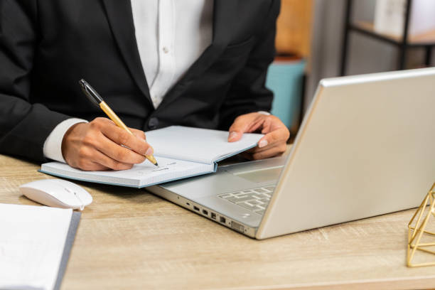 istock Close-up hands of focused businessman writing notes startup project ideas in notebook at home office 1776777432