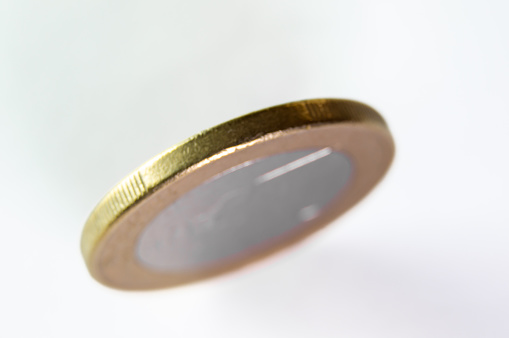 Elevated View: One Euro Coin in Macro Focus from a Lateral Perspective.