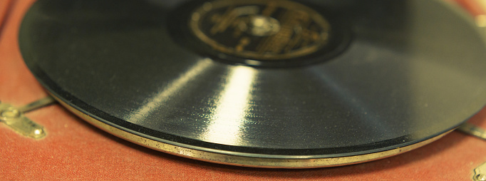 Photography of retro vinyl turntable and vinyl plate. Close frontal view. View from above, top view.