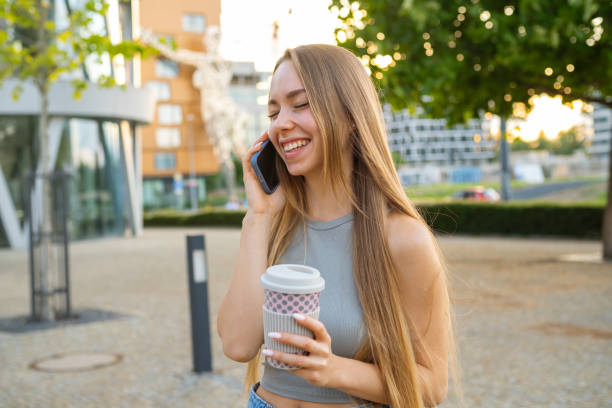istock Young woman drinks coffee talking on phone with boyfriend 1776804479