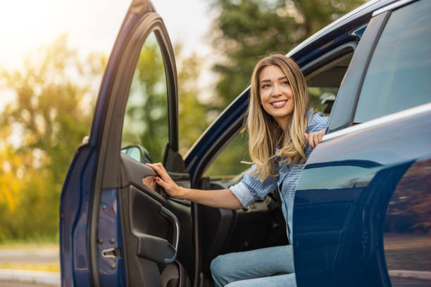 istock Young woman driving a car and smiling 1776805085