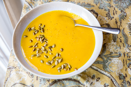 Blended pumpkin puree soup made with coconut milk, pumpkin, onions and garlic