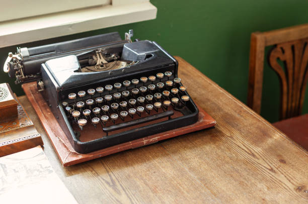 istock Retro typewriter on a wooden table near the daylight rays window 1776808300