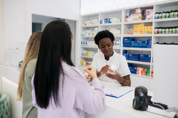 istock Pharmacist assisting female customers at checkout counter 1776811231