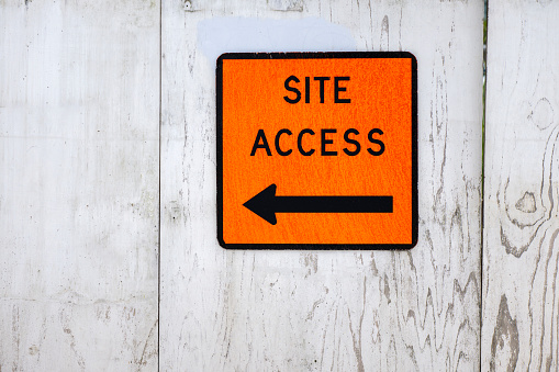 Site Access directional sign on wooden wall