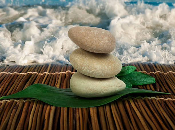 istock Stacked stones on wooden base for spa and green leafs 177688112