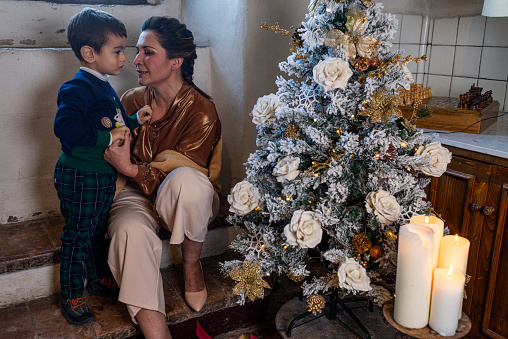 Mother with her son under the Christmas tree