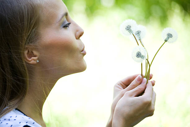 istock Young woman with dandelions 177689937