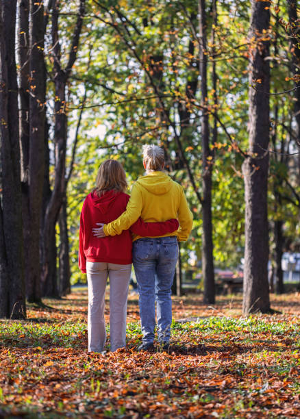 istock Mother and Daughter Enjoying Autumn Forest 1776910360