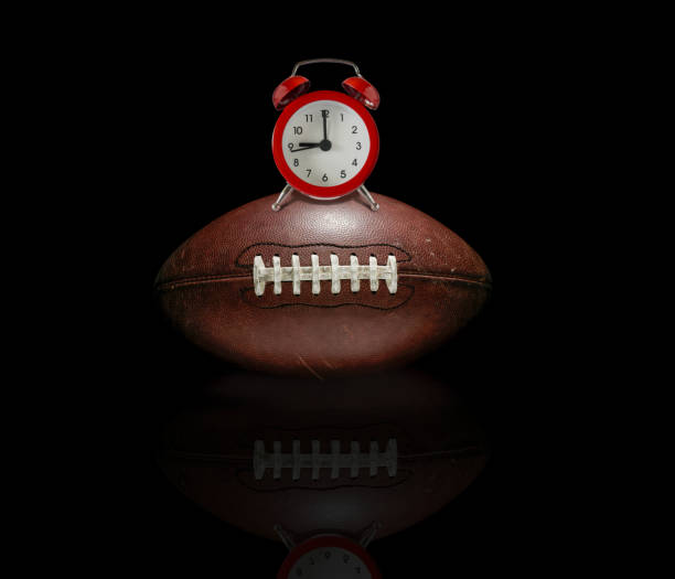 A muddy dirty american football ball caught in slow motion flying through the air scattering mud particles in its wake - 3D render