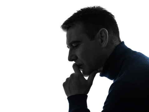 one caucasian man serious thinking pensive portrait in silhouette studio   on white background