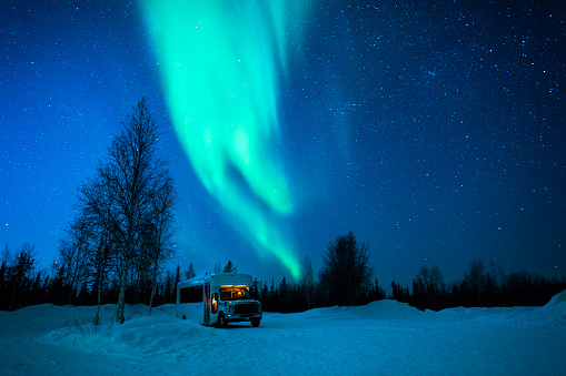 Aurora Borealis, northern lights, above a bus on a freezing cold winter night in the Northwest Territories, Yellowknife, Alberta, Canada