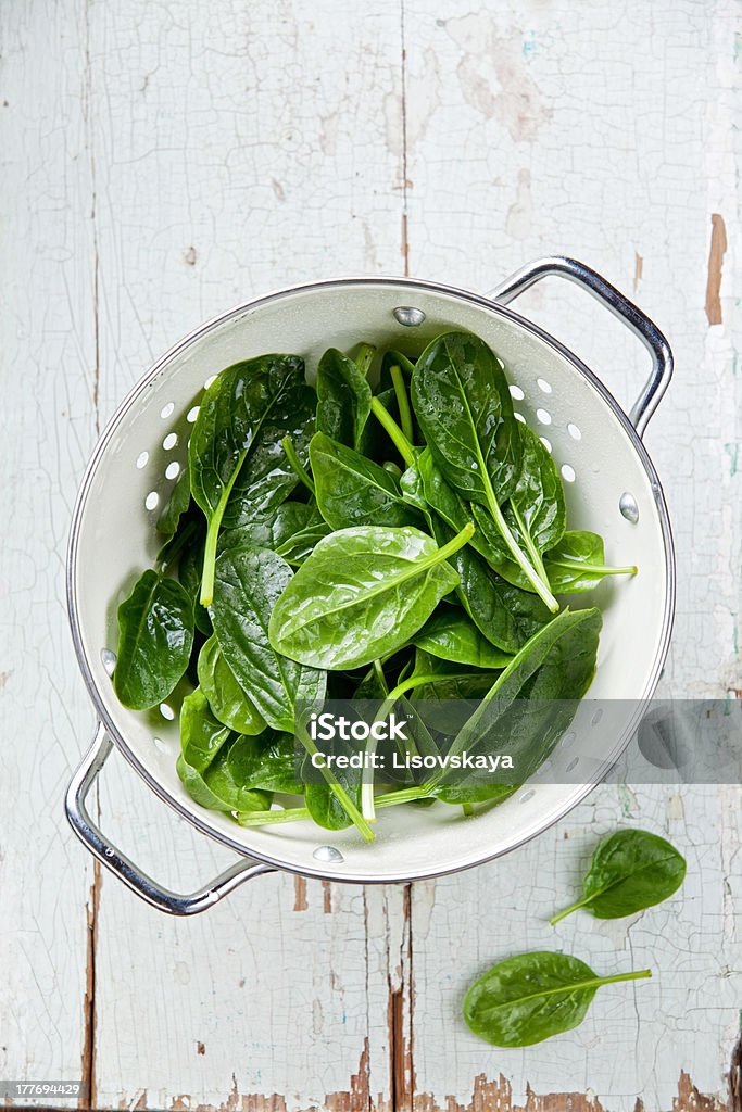Young spinach Young spinach in colander Colander Stock Photo