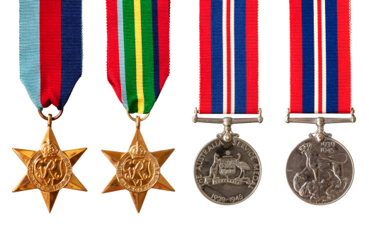 Collection of British and Australian World War II military medals, isolated on white.  Includes the 1939-1945 Star, the Pacific Star, and the Australian and British Service Medals.