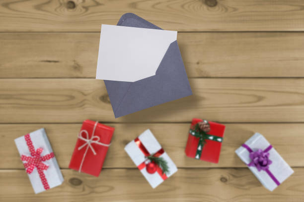 istock Mockup Christmas greeting card top view and open envelope, gifts. 1776968567