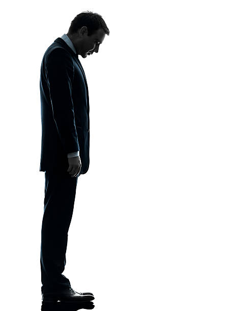 istock Silhouette of man in a suit looking down at his feet 177698253