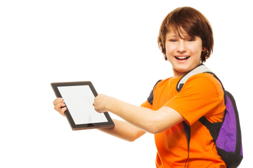 Smart Caucasian 11 years old boy showing new application on digital tablet computer, standing isolated on white
