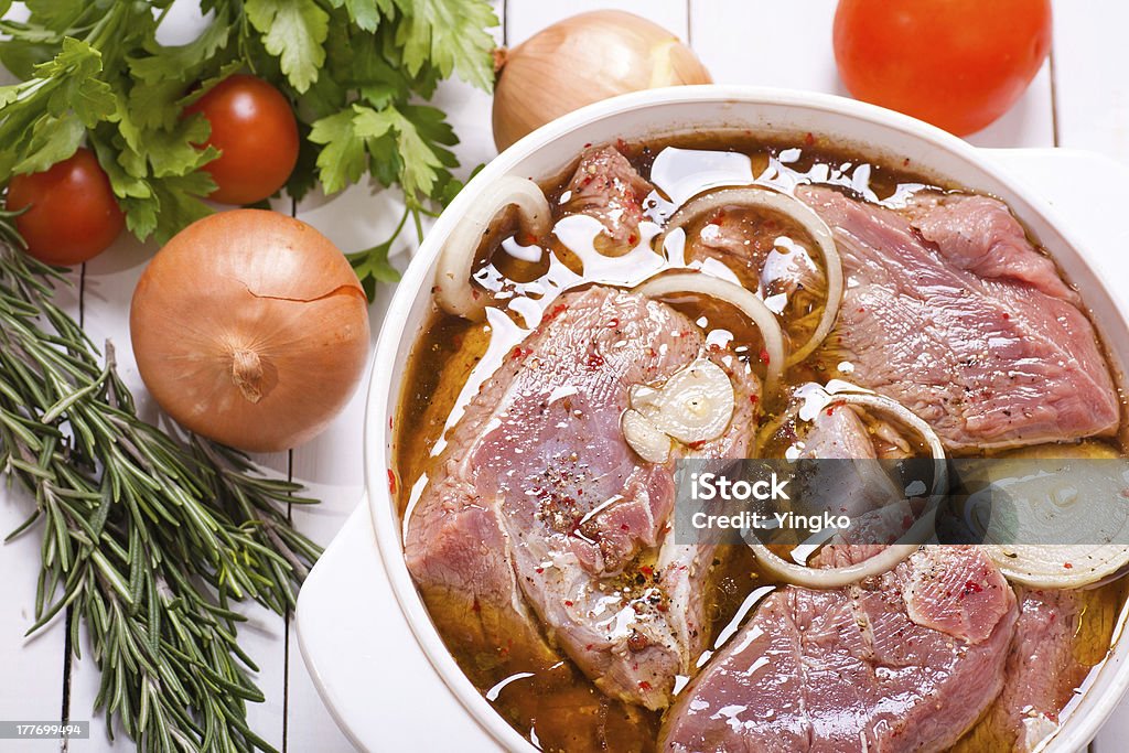 Marinating meat Marinating meat with spices and onion Marinated Stock Photo