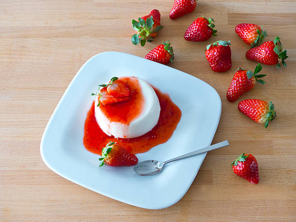 Panna cotta on a plate and wood stock photo