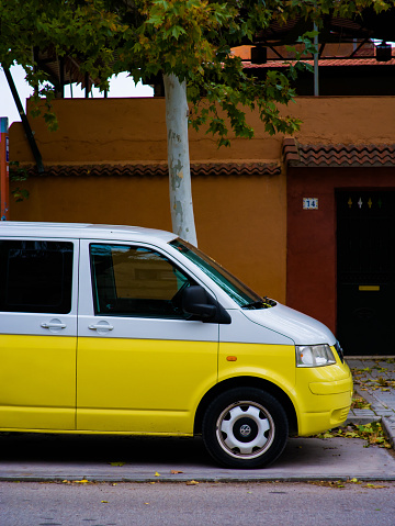 yellow and white van parked on a street in Aranjuez Madrid Spain