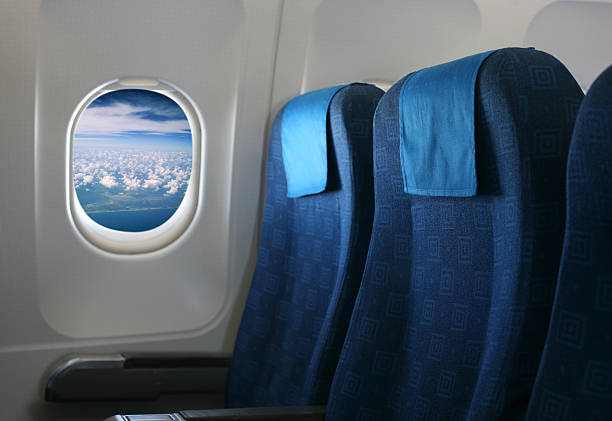 istock Blue airplane seats and a view of a cloudy sky 177701588