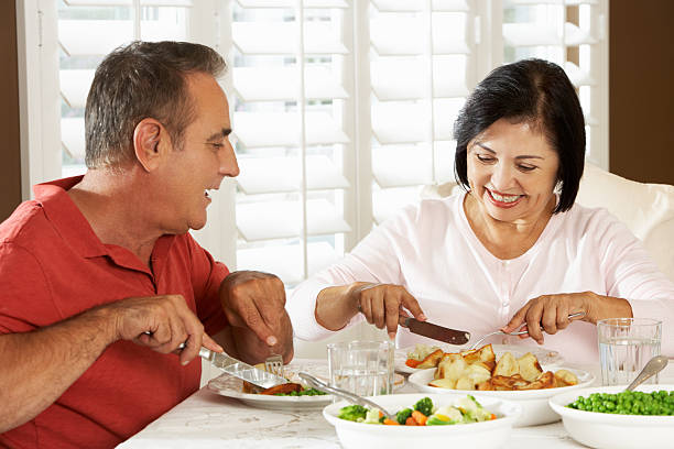 istock Senior Couple Enjoying Meal At Home 177703042