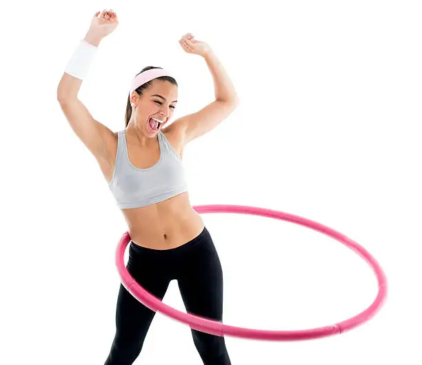 Beautiful girl doing hula hoop. Isolated over white background