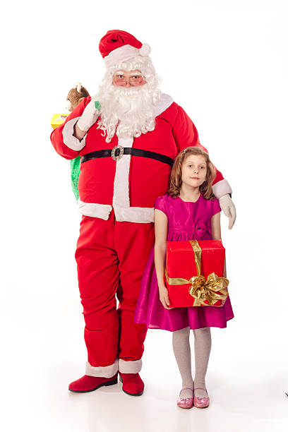 Santa Claus holding  bag and little girl - gift stock photo