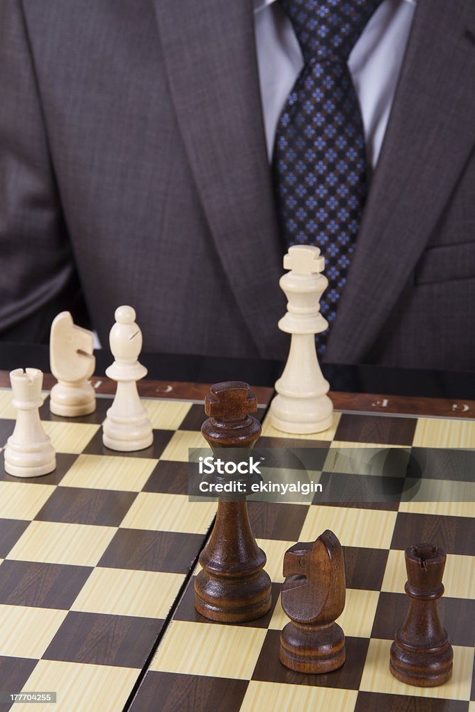 Businessman Playing Chess Businessman in suit playing chess on board. Arts Culture and Entertainment Stock Photo