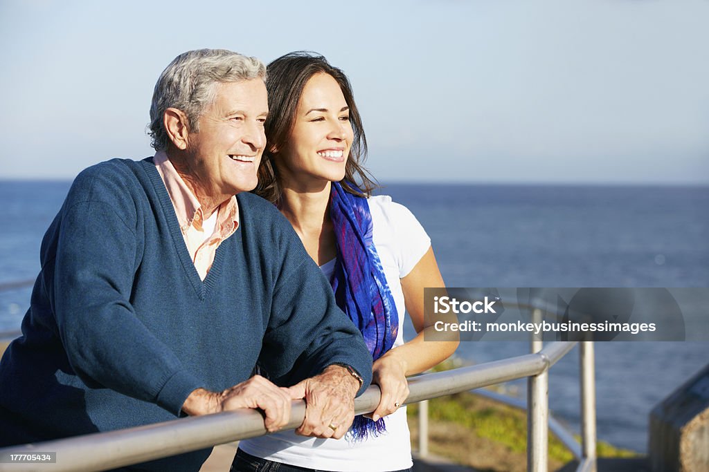 Senior Man With Adult Daughter Looking Over Railing At Sea Senior Man With Adult Daughter Looking Over Railing At Sea Smiling 30-39 Years Stock Photo