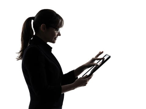 one business woman computer computing typing digital tablet  silhouette studio on white background