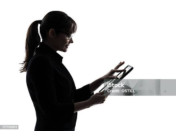 Silhouette Of A Woman Using A Table Over A White Background Stock Photo - Download Image Now