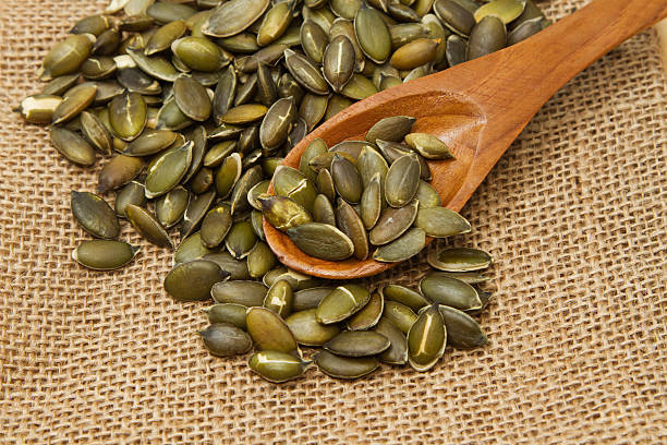 istock Pumpkin seeds in wooden spoon 177707397