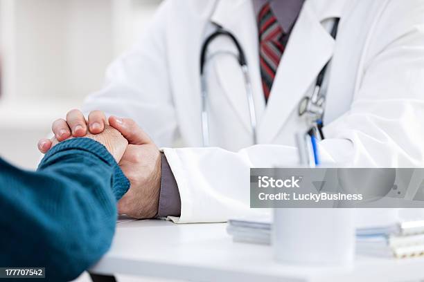 A Doctor Assuring His Patient By Holding Her Hand Stock Photo - Download Image Now - Adult, Care, Communication