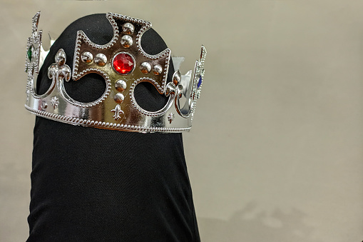 A plastic crown with jewels.