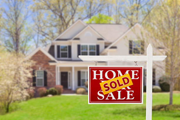 Sold Home For Sale Real Estate Sign and House stock photo