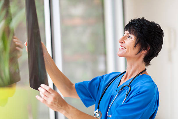 istock female middle aged medical surgeon looking at x-ray 177709578