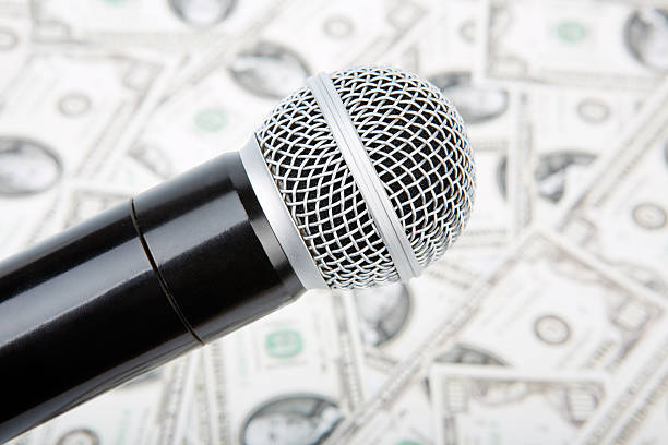 Microphone and money Professional microphone and money, against money ben singer stock pictures, royalty-free photos & images