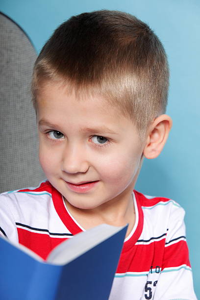 istock Closeup child boy with a book 177710766