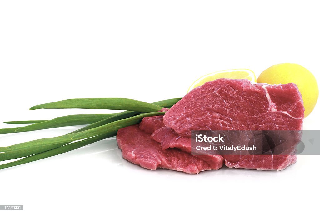 Cut of  beef steak Cut of  beef steak with lemon slice and onion. Isolated. Beef Stock Photo